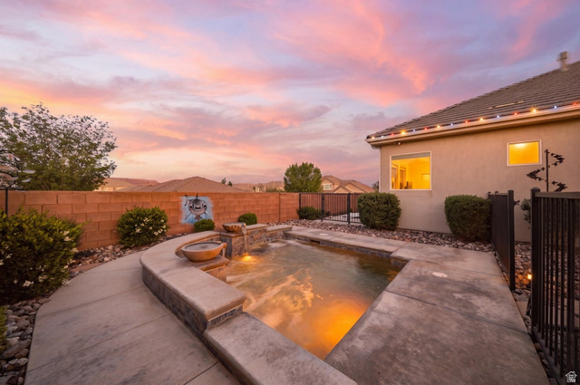 2829 East 1880th Street South St. George, UT 84790 - Photo 47 of 54 Pool at dusk featuring an in-ground hot tub, a fenced backyard, and a patio area