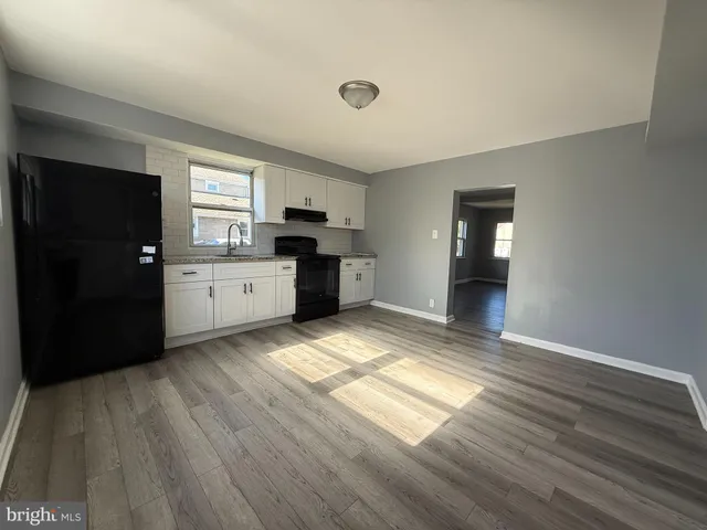 a view of wooden floor and windows in a room