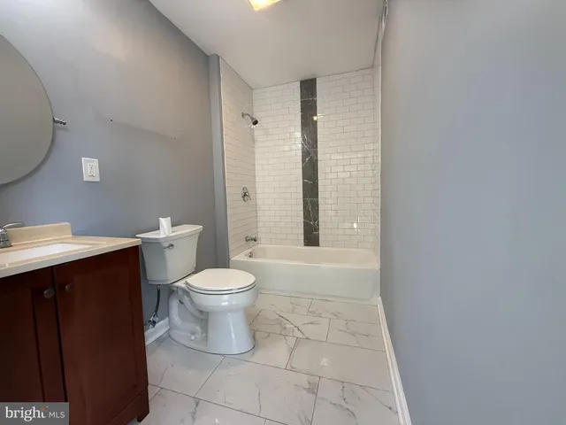 a bathroom with a toilet a sink and shower