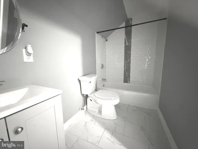 a white toilet sitting next to a bathroom sink
