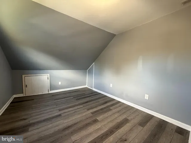 a view of an empty room and wooden floor