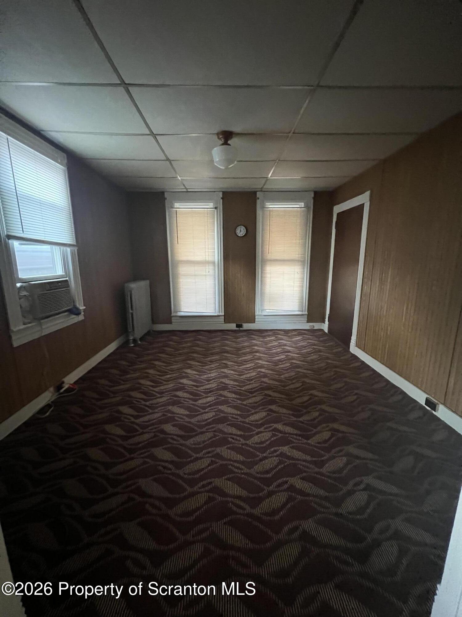 812 Butler Street Dunmore, PA 18512 - Photo 10 of 15 a view of an empty room with window and wooden floor
