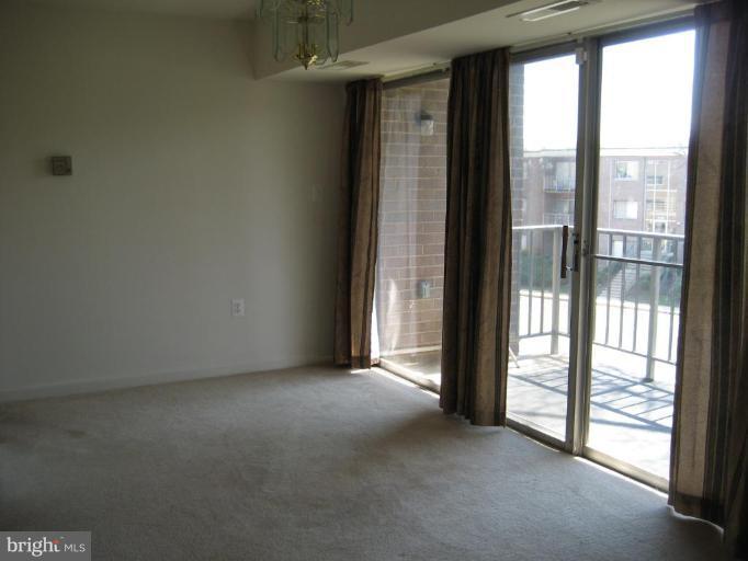 3814 Bel Pre Road, Unit 38149 Silver Spring, MD 20906 - Photo 22 of 27 a view of empty room with floor to ceiling window