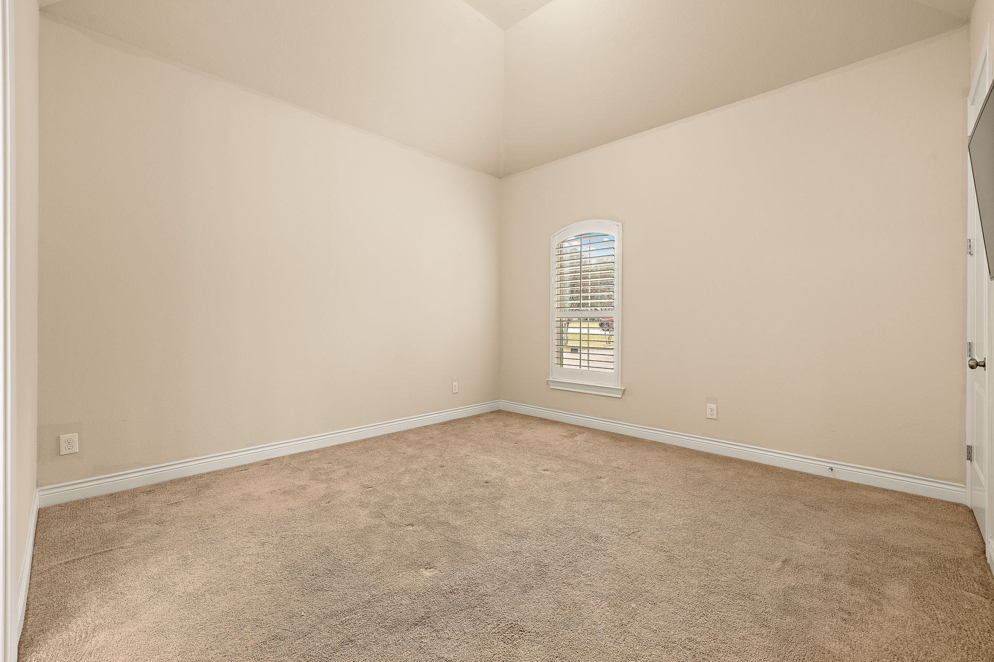 174 Estrella Crossing Georgetown, TX 78628 - Photo 20 of 38 Unfurnished room featuring light carpet and vaulted ceiling