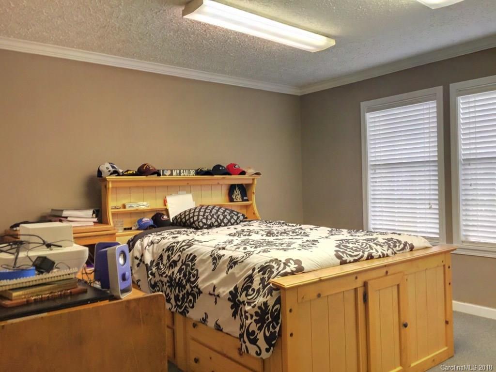 2915 Locust Grove Road Hendersonville, NC 28792 - Photo 12 of 30 a bedroom with a bed and a window