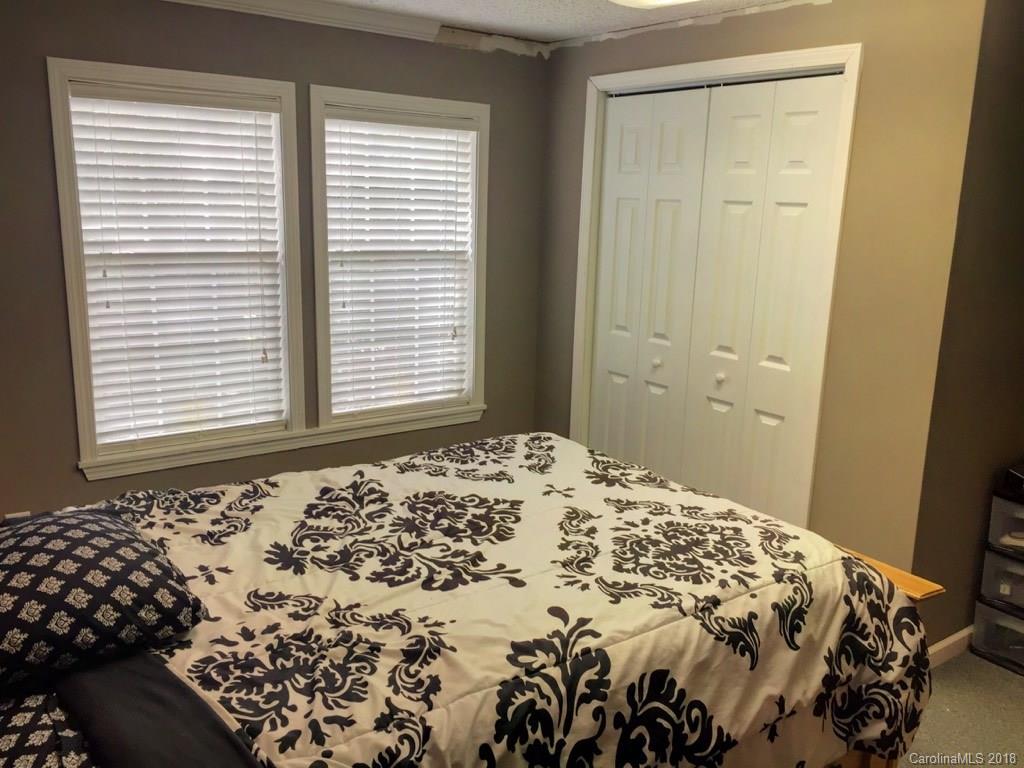 2915 Locust Grove Road Hendersonville, NC 28792 - Photo 13 of 30 a bedroom with a bed and a window