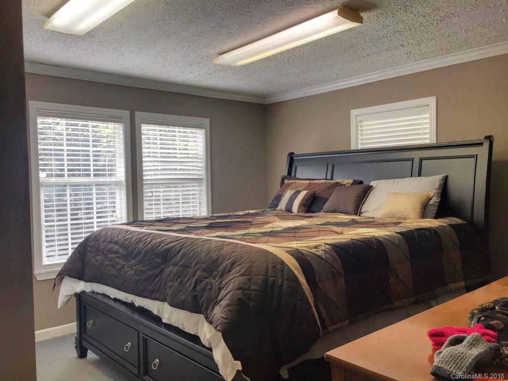 2915 Locust Grove Road Hendersonville, NC 28792 - Photo 14 of 30 a bedroom with a bed and window