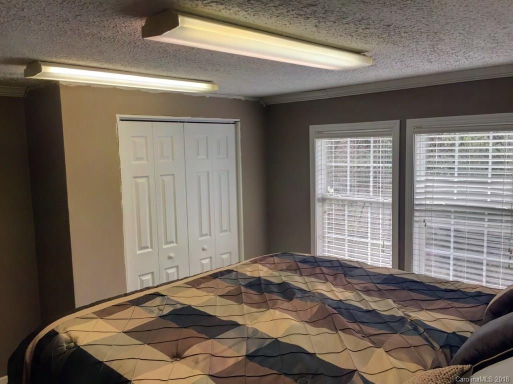 2915 Locust Grove Road Hendersonville, NC 28792 - Photo 15 of 30 a bedroom with a bed and a window