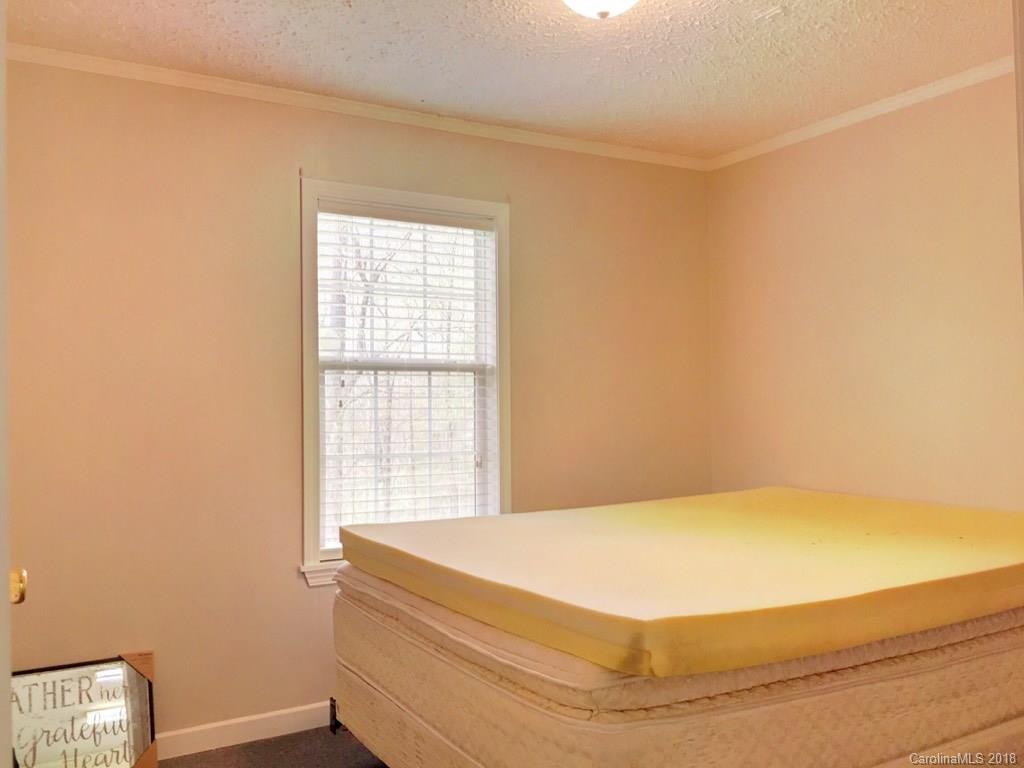 2915 Locust Grove Road Hendersonville, NC 28792 - Photo 21 of 30 a bedroom with a bed and a window