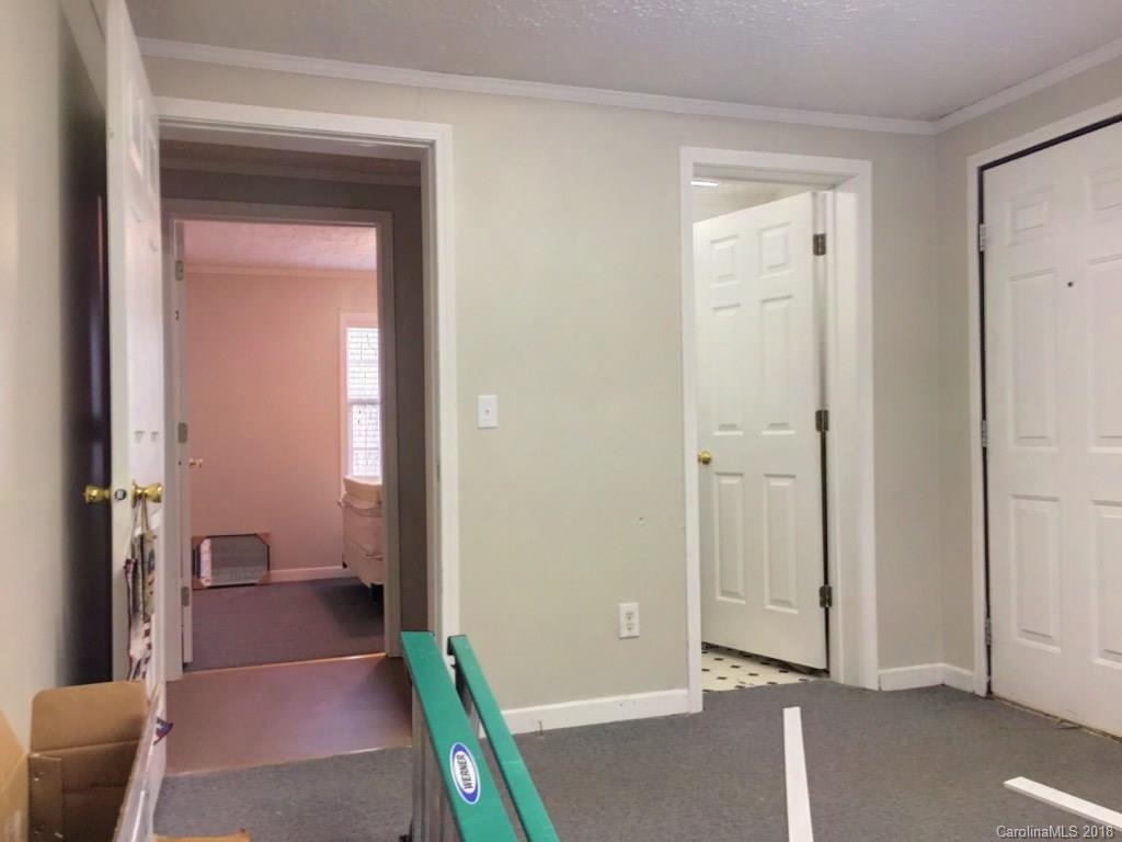 2915 Locust Grove Road Hendersonville, NC 28792 - Photo 23 of 30 a view of a hallway with wooden floor and a livingroom