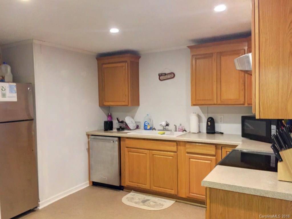 2915 Locust Grove Road Hendersonville, NC 28792 - Photo 25 of 30 a kitchen with a sink a stove and cabinets