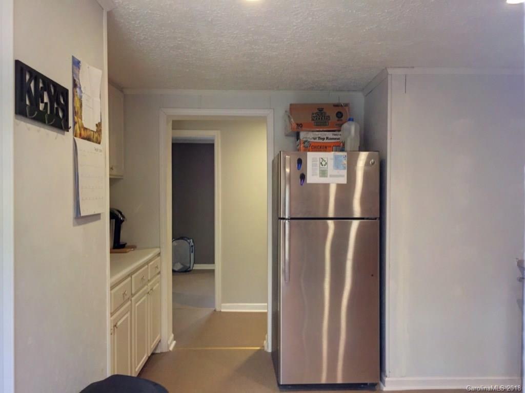 2915 Locust Grove Road Hendersonville, NC 28792 - Photo 26 of 30 a view of a refrigerator in kitchen and an empty room