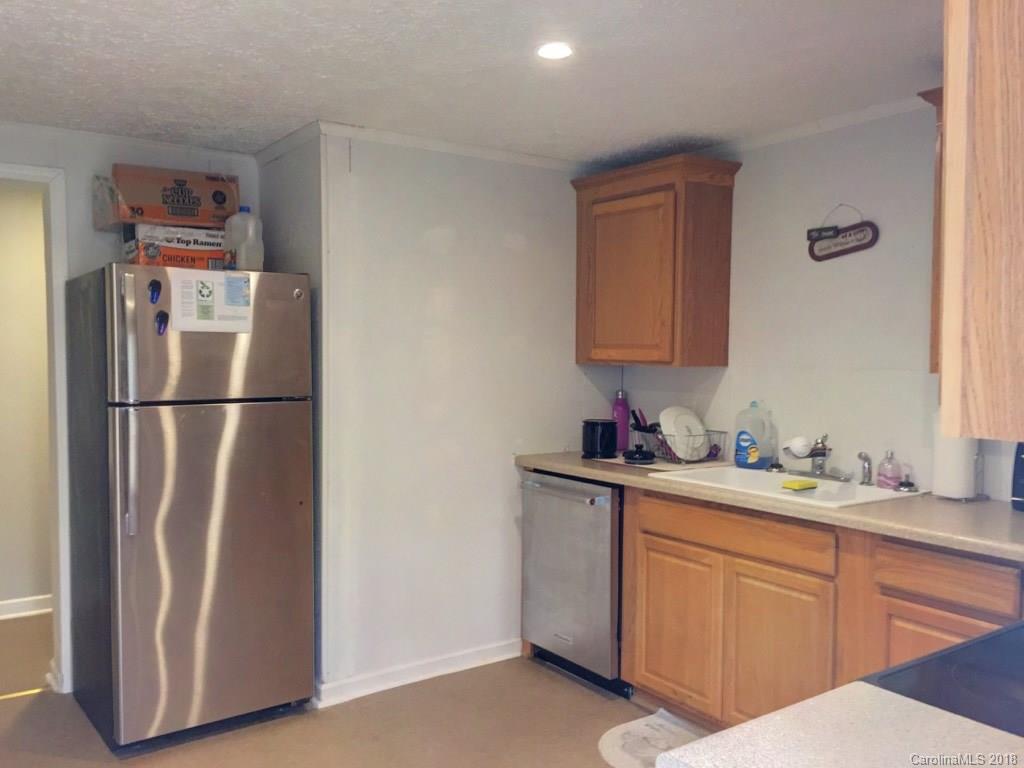 2915 Locust Grove Road Hendersonville, NC 28792 - Photo 27 of 30 a kitchen with a refrigerator sink and cabinets