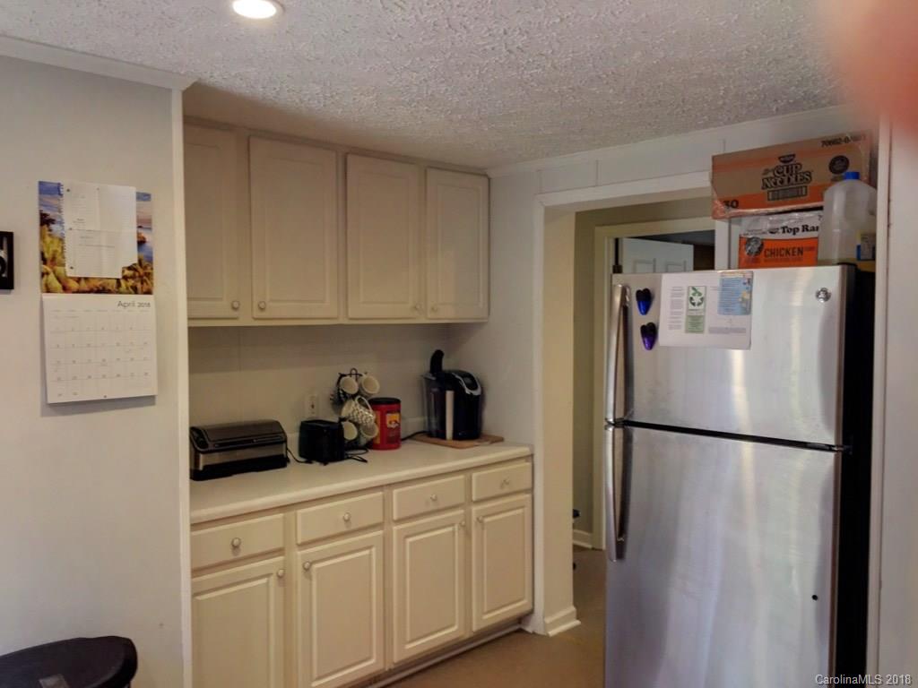 2915 Locust Grove Road Hendersonville, NC 28792 - Photo 28 of 30 a kitchen with stainless steel appliances a refrigerator and cabinets