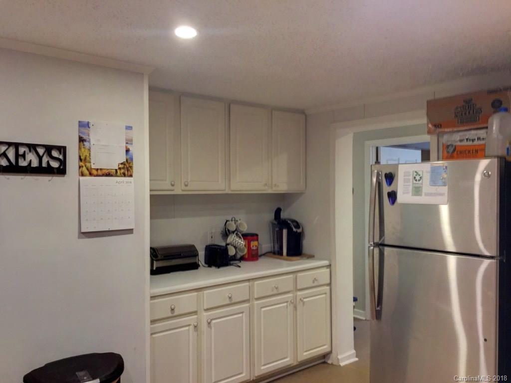 2915 Locust Grove Road Hendersonville, NC 28792 - Photo 29 of 30 a kitchen with stainless steel appliances a refrigerator sink and cabinets