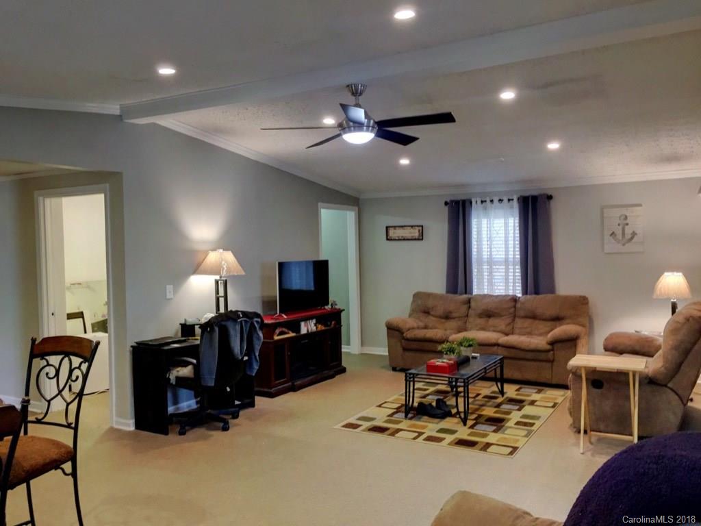 2915 Locust Grove Road Hendersonville, NC 28792 - Photo 6 of 30 a living room with furniture and a flat screen tv