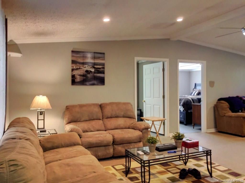 2915 Locust Grove Road Hendersonville, NC 28792 - Photo 8 of 30 a living room with furniture and a lamp