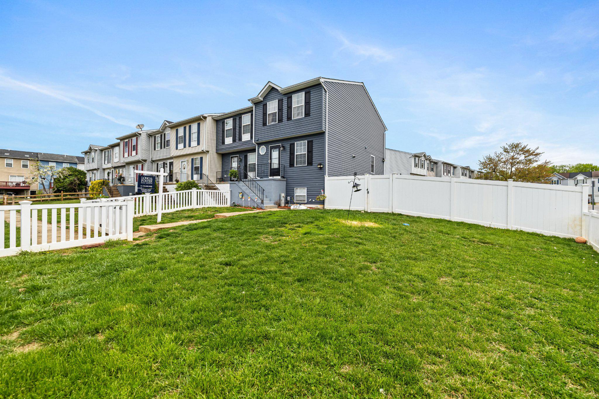 a view of a house with a yard and sitting area