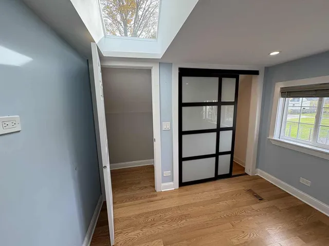 an empty room with windows and closet