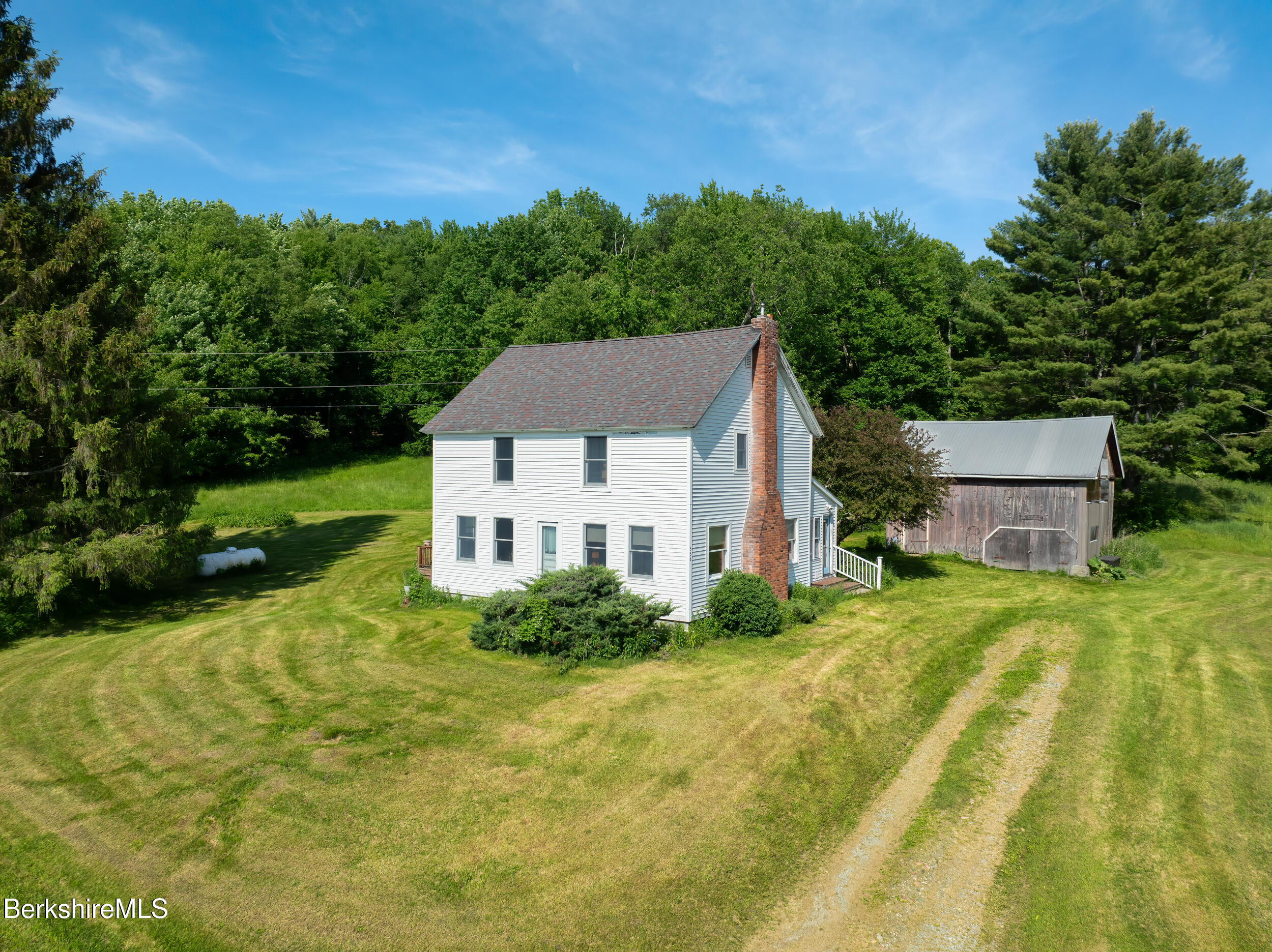 556 Mann Hill Road Pownal, VT 05261 - Photo 1 of 36 a house view with a garden space