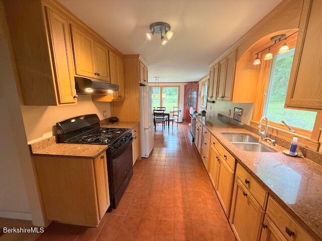 556 Mann Hill Road Pownal, VT 05261 - Photo 14 of 36 a kitchen with stainless steel appliances a stove a sink a refrigerator and cabinets
