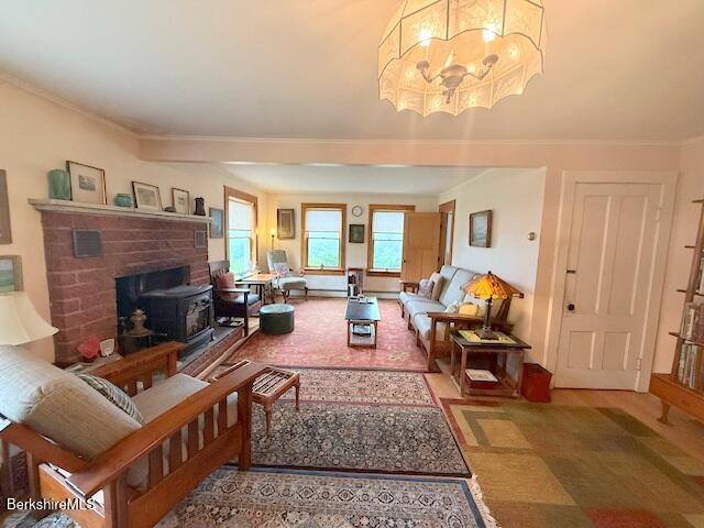 556 Mann Hill Road Pownal, VT 05261 - Photo 21 of 36 a living room with furniture a fireplace and a chandelier