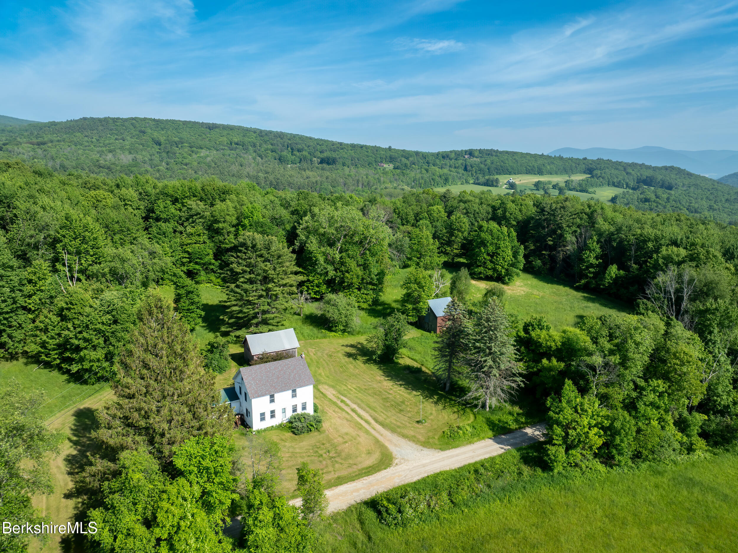 556 Mann Hill Road Pownal, VT 05261 - Photo 8 of 36 an aerial view of residential houses with outdoor space and trees all around
