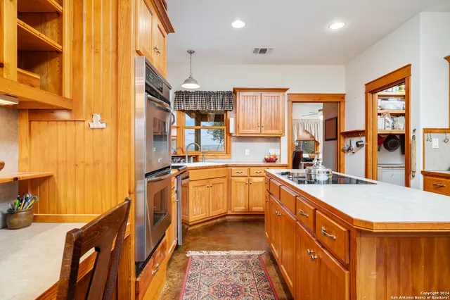 a bathroom with a granite countertop toilet a sink and a mirror