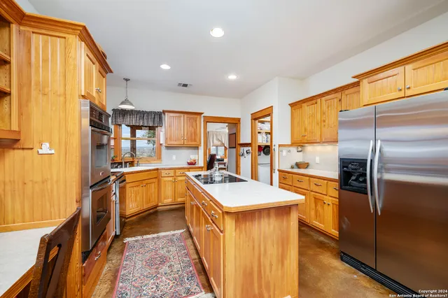 a view of a backyard with table and chairs under an umbrella