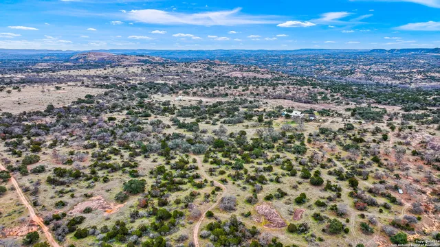 an aerial view of residential houses with city view