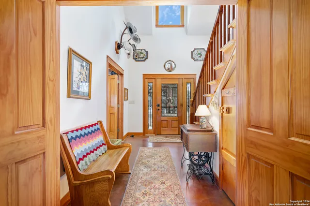 a kitchen with stainless steel appliances granite countertop a refrigerator a stove top oven a sink dishwasher and white cabinets with wooden floor