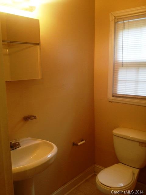 1314 Skyview Road Charlotte, NC 28208 - Photo 9 of 12 a bathroom with a sink and a mirror