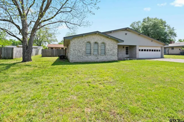 a house with huge green field in front of it