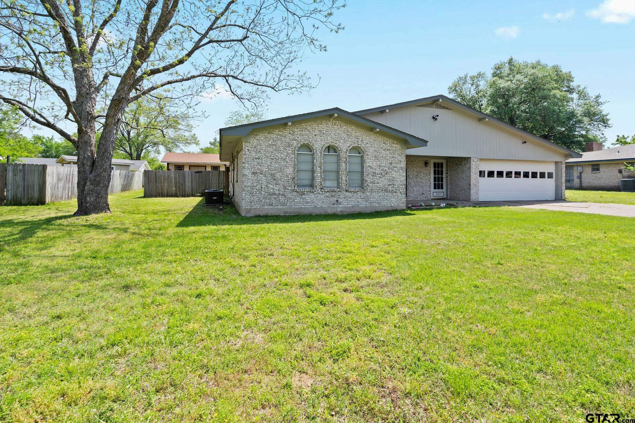 a house with huge green field in front of it