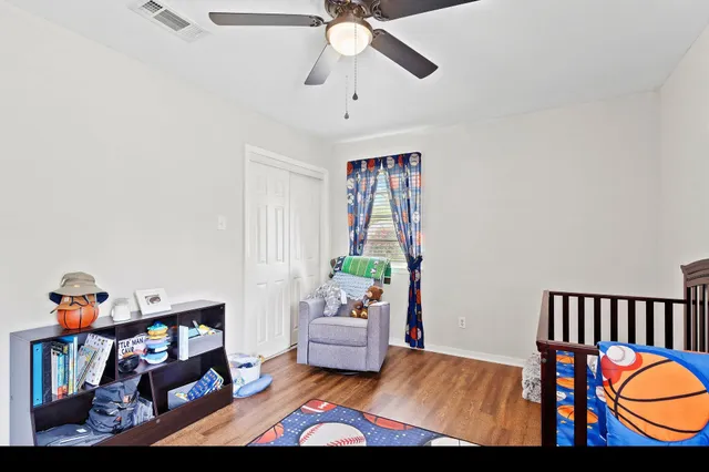 a view of a workspace with furniture and wooden floor