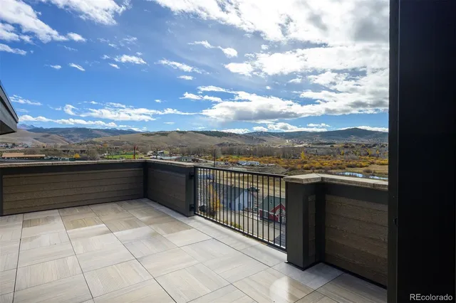 a view of empty room with a fireplace and wooden floor