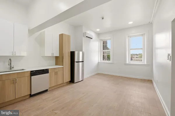 a kitchen with stainless steel appliances a refrigerator sink and cabinets
