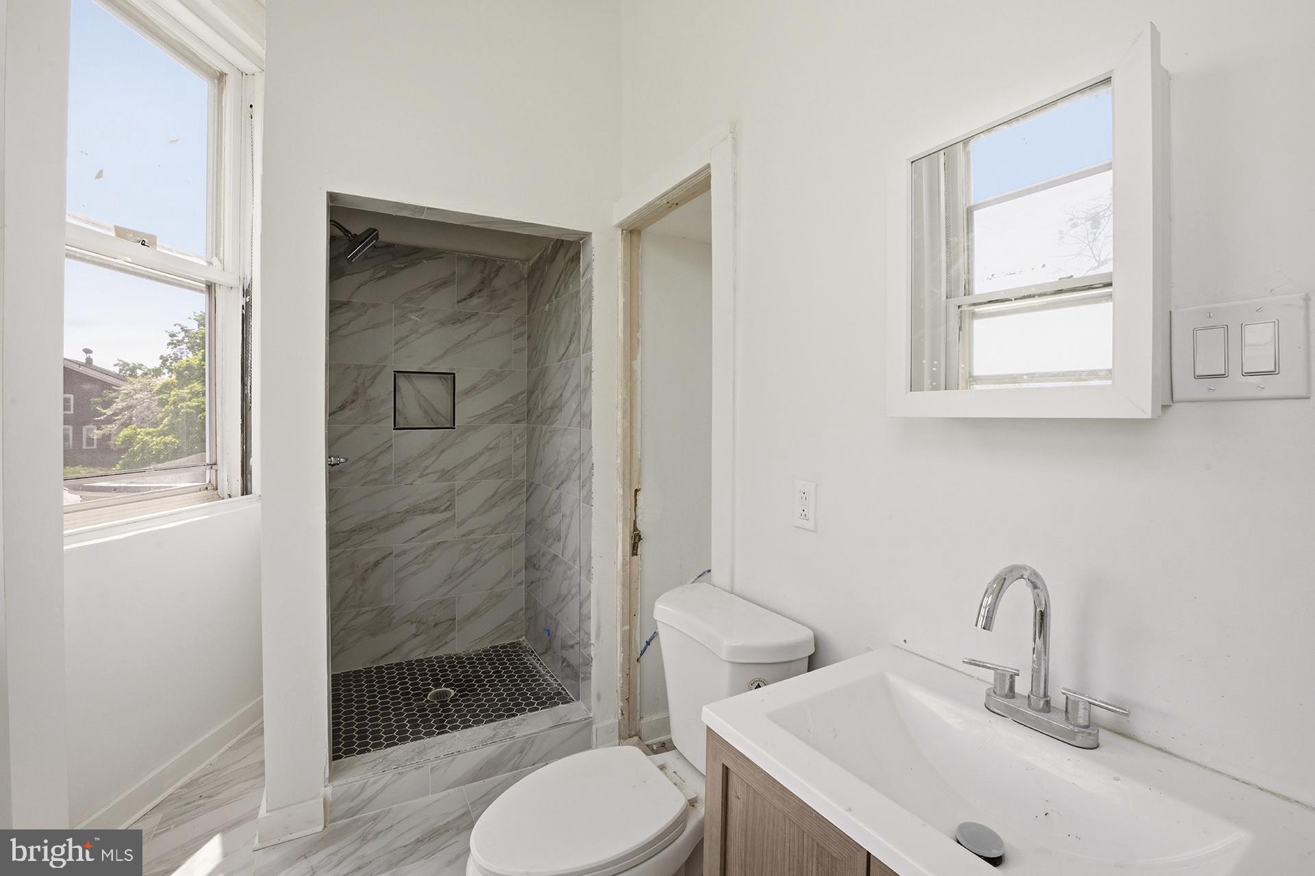 6012 Ridge Avenue, Unit 5 Philadelphia, PA 19128 - Photo 14 of 19 a bathroom with a sink toilet and shower