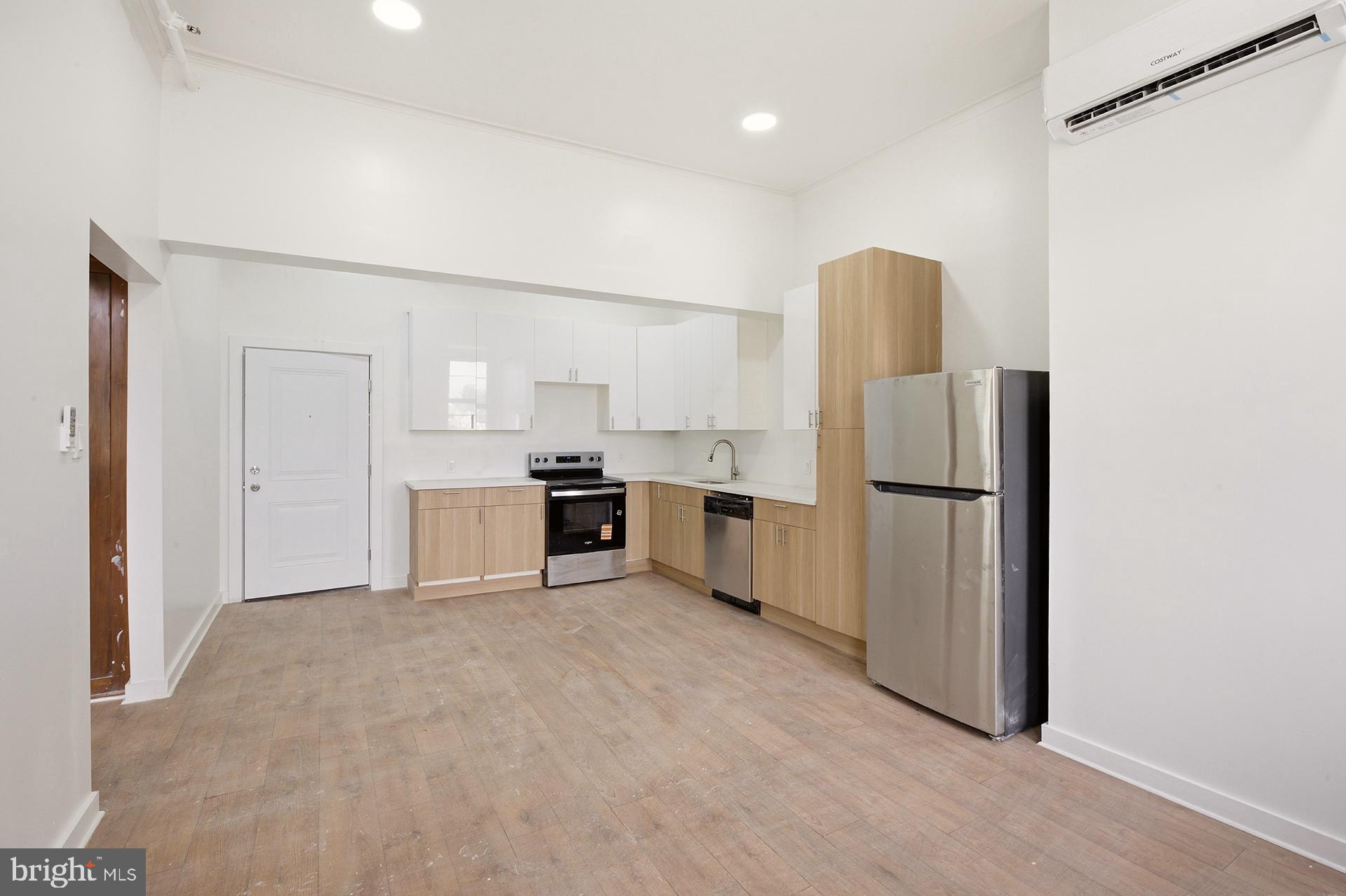 6012 Ridge Avenue, Unit 5 Philadelphia, PA 19128 - Photo 2 of 19 a kitchen with white cabinets and stainless steel appliances