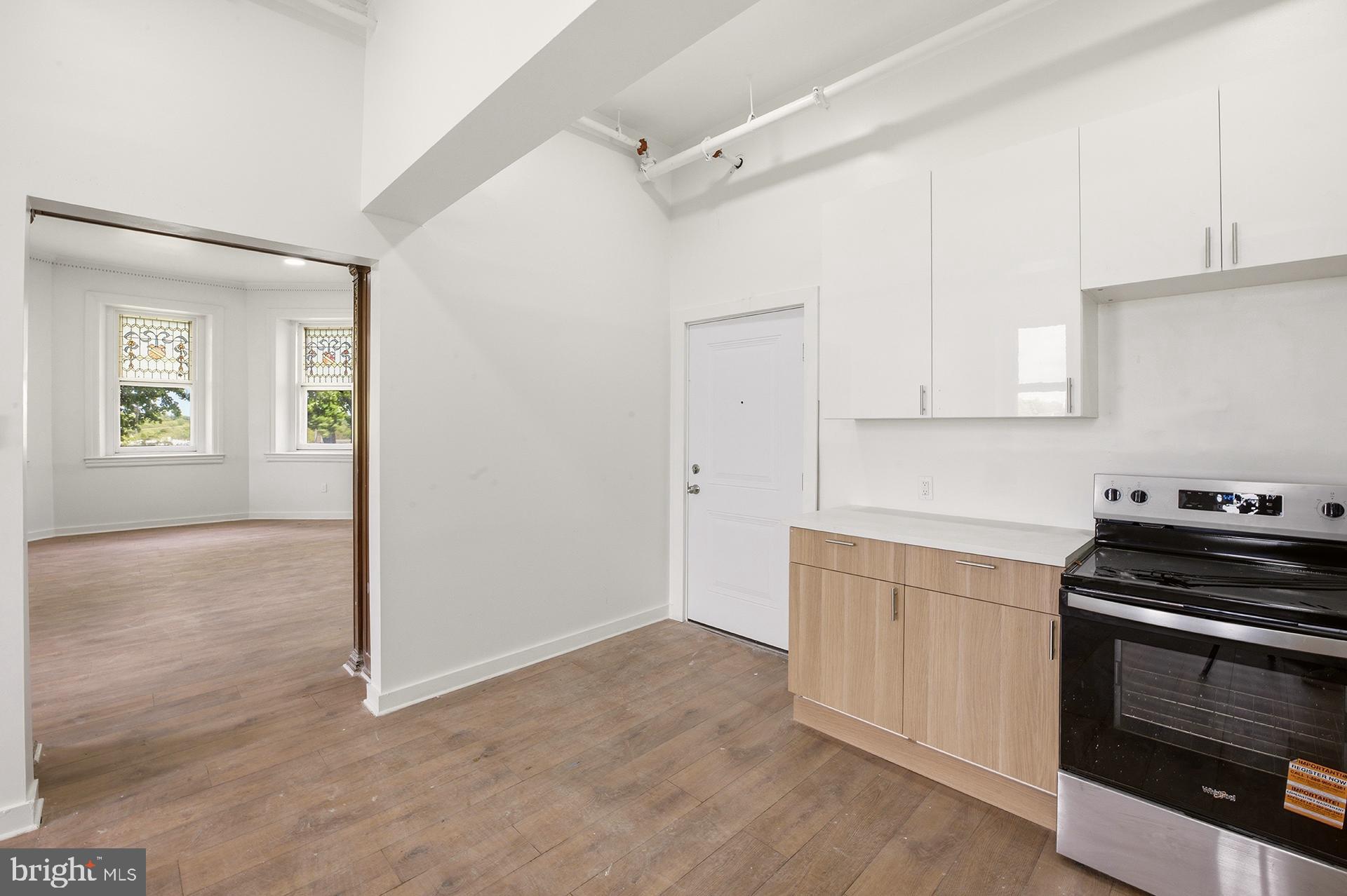 6012 Ridge Avenue, Unit 5 Philadelphia, PA 19128 - Photo 3 of 19 a kitchen with granite countertop a stove and a sink