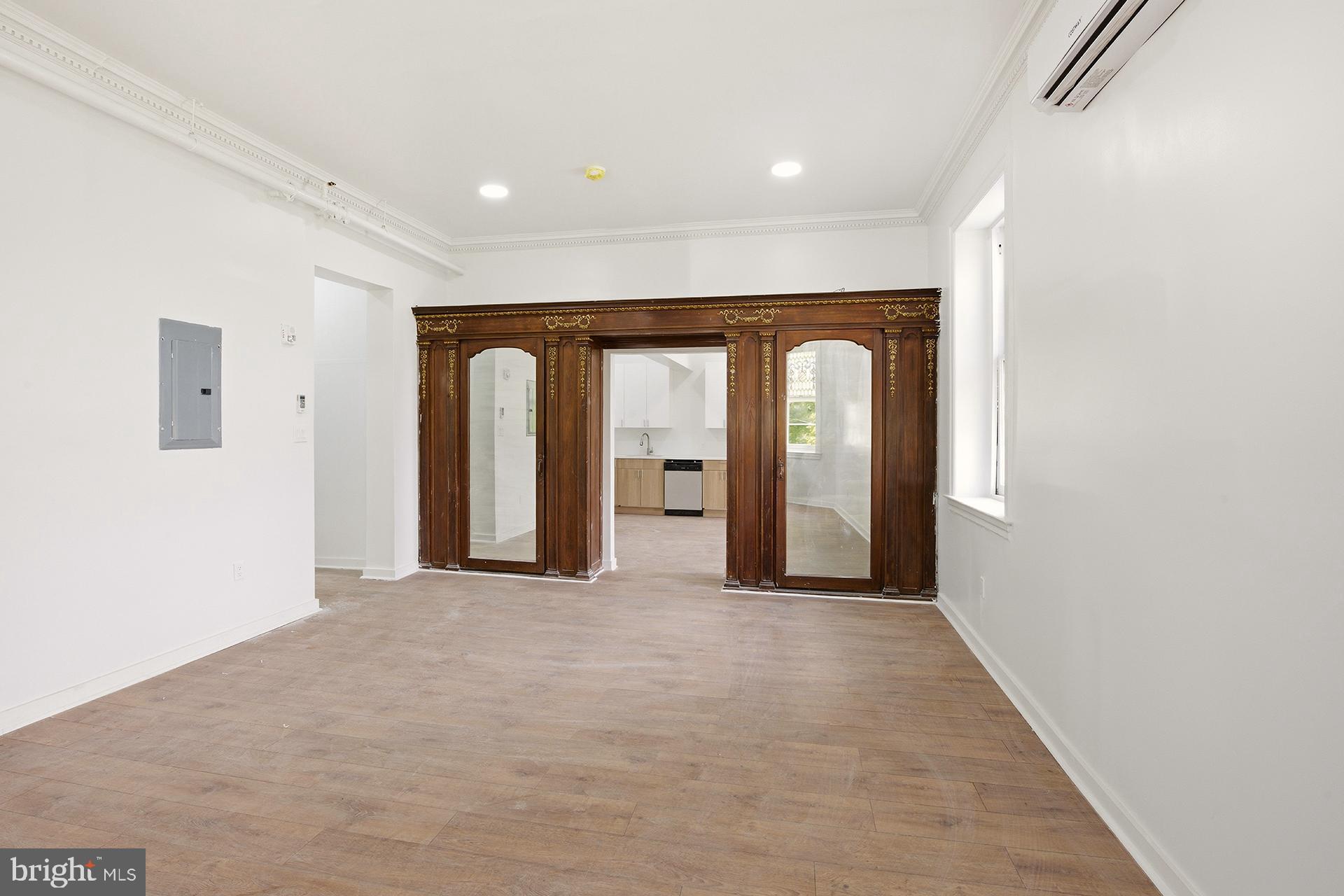 6012 Ridge Avenue, Unit 5 Philadelphia, PA 19128 - Photo 6 of 19 a view of a big room with wooden floor and furniture