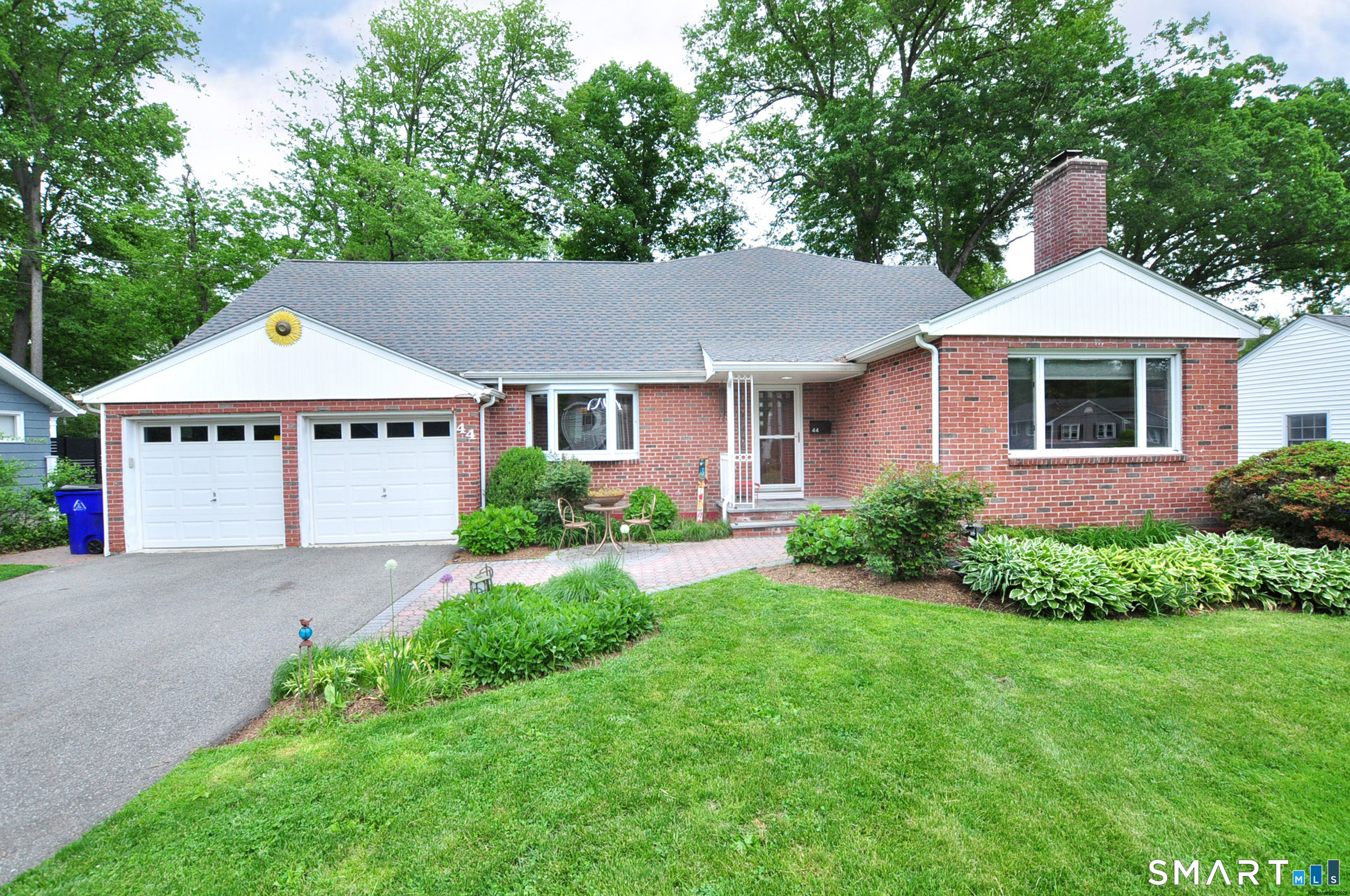 44 Miamis Road West Hartford, CT 06117 - Photo 1 of 39 a front view of a house with a yard and garage