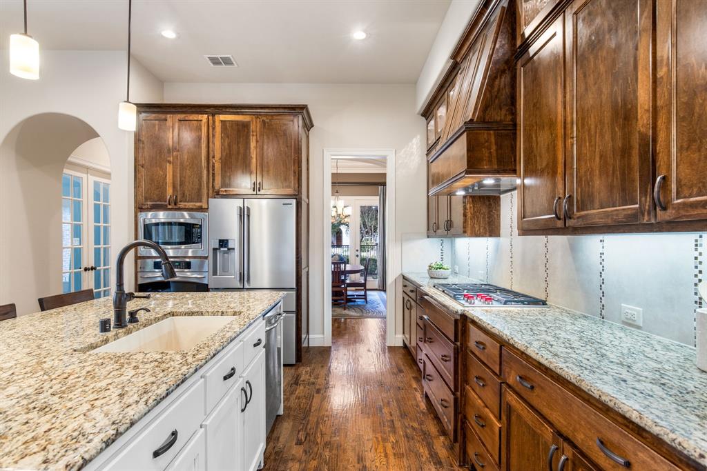 4111 Broadmoor Way Frisco, TX 75033 - Photo 12 of 38 a kitchen with stainless steel appliances granite countertop a sink stove and refrigerator