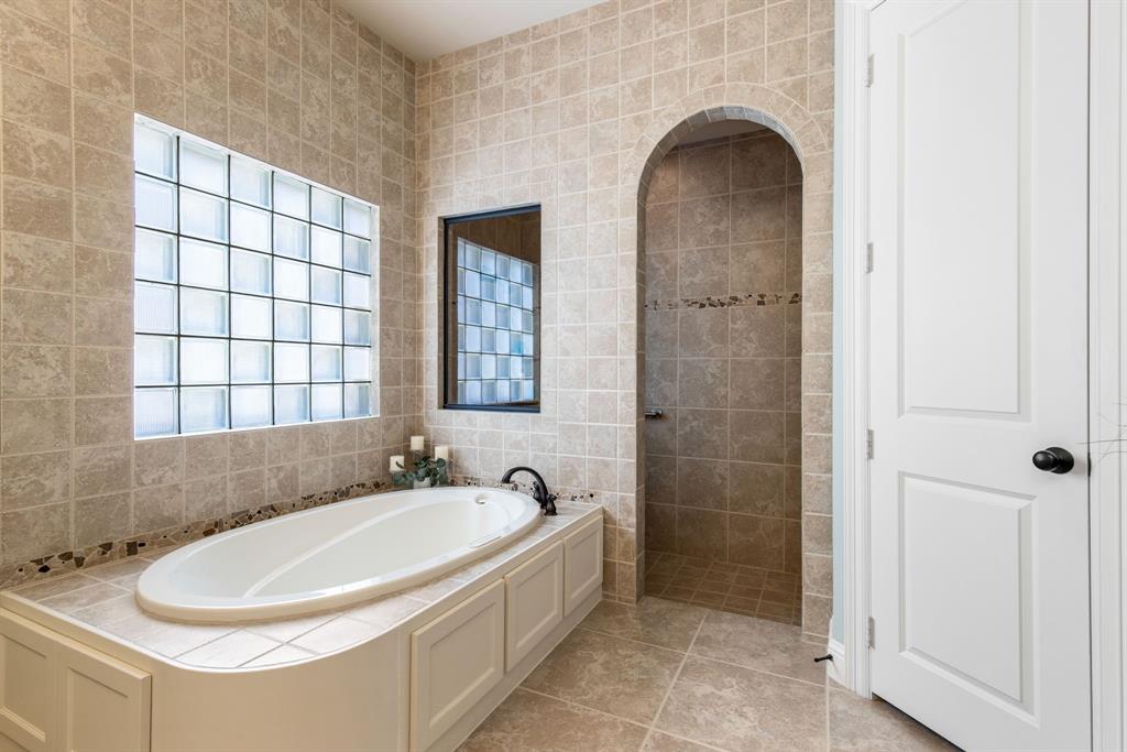 4111 Broadmoor Way Frisco, TX 75033 - Photo 17 of 38 a bathroom with a bathtub and a shower