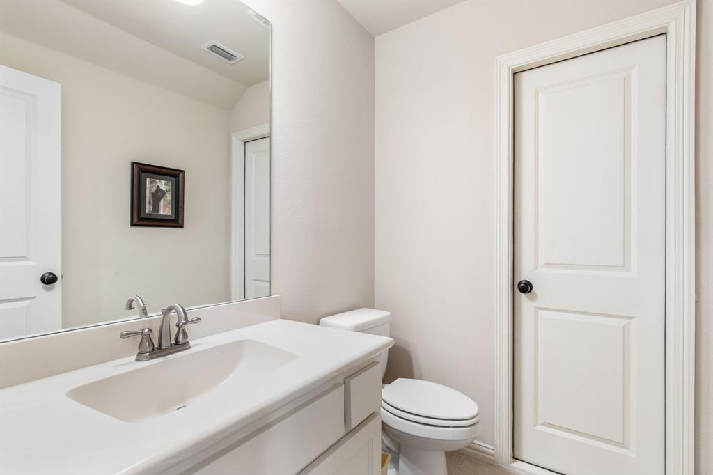 4111 Broadmoor Way Frisco, TX 75033 - Photo 29 of 38 a bathroom with a sink a toilet and a mirror