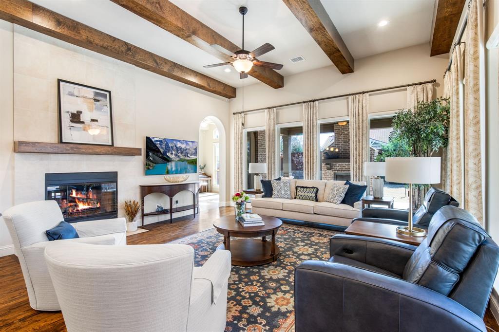 4111 Broadmoor Way Frisco, TX 75033 - Photo 8 of 38 a living room with furniture a fireplace and a chandelier