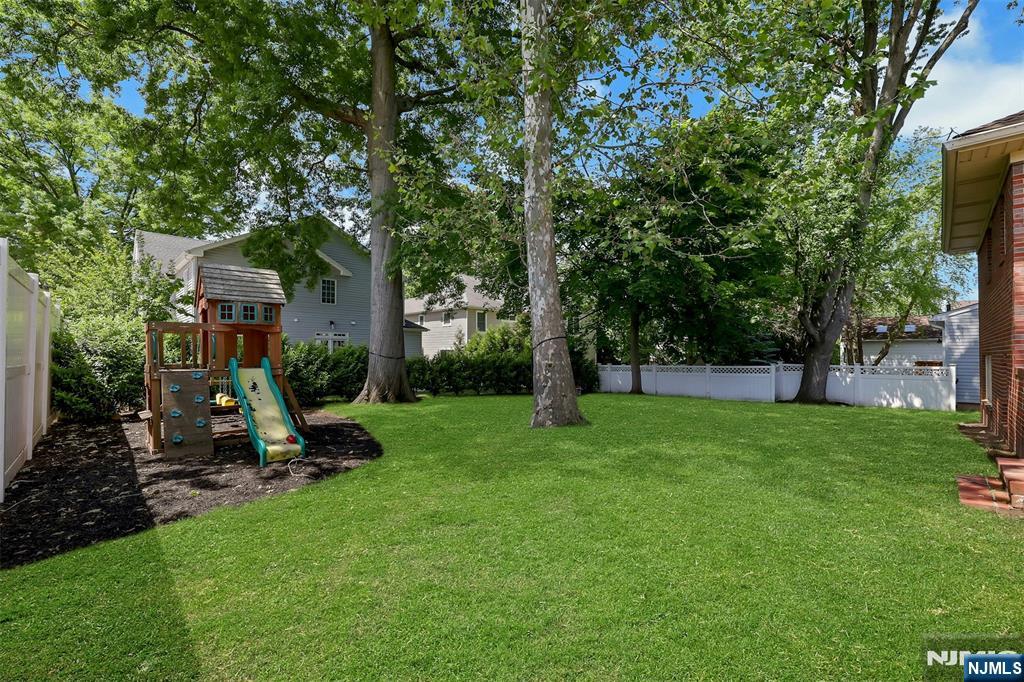 514 Rutland Avenue Teaneck, NJ 07666 - Photo 35 of 40 a view of a backyard with a large tree