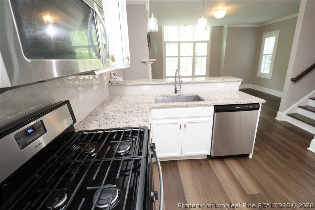 2824 Plumfield Place Raleigh, NC 27607 - Photo 11 of 33 a kitchen with a sink stove and cabinets