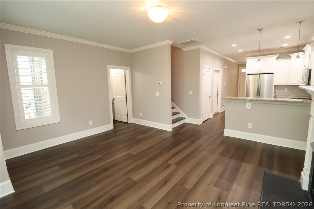 2824 Plumfield Place Raleigh, NC 27607 - Photo 16 of 33 a view of wooden floor and windows in an empty room