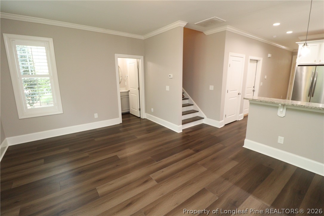 2824 Plumfield Place Raleigh, NC 27607 - Photo 17 of 33 an empty room with wooden floor and windows